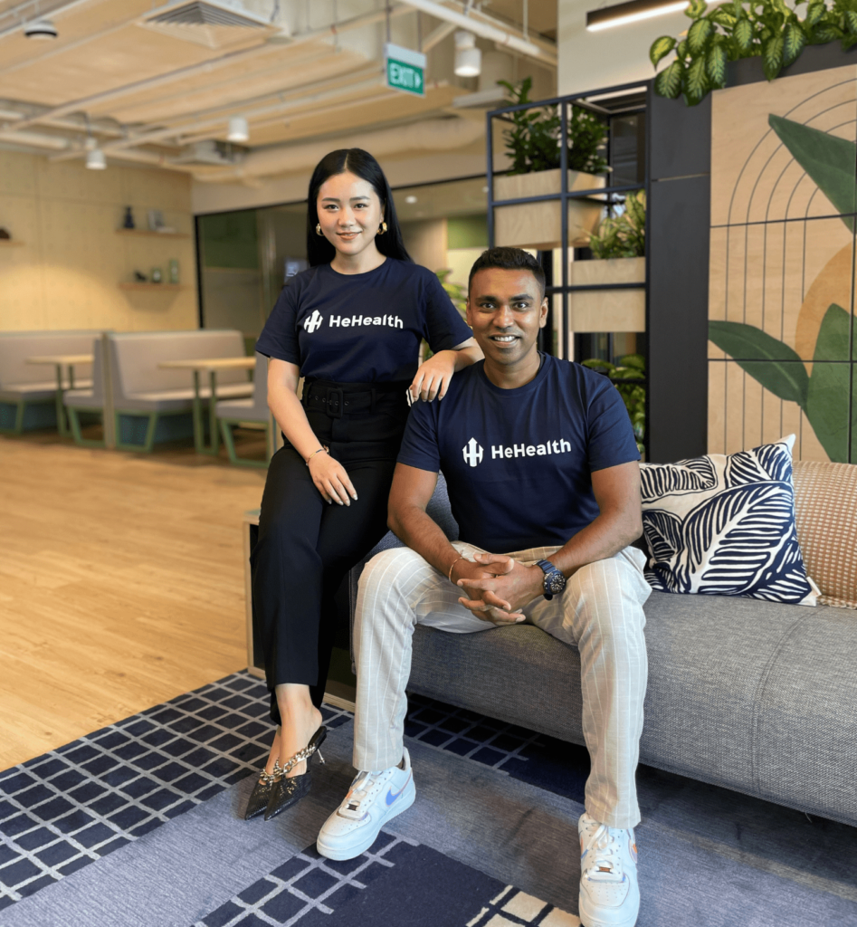 HeHealth co-founders in branded tees seated in a modern Singapore office lounge