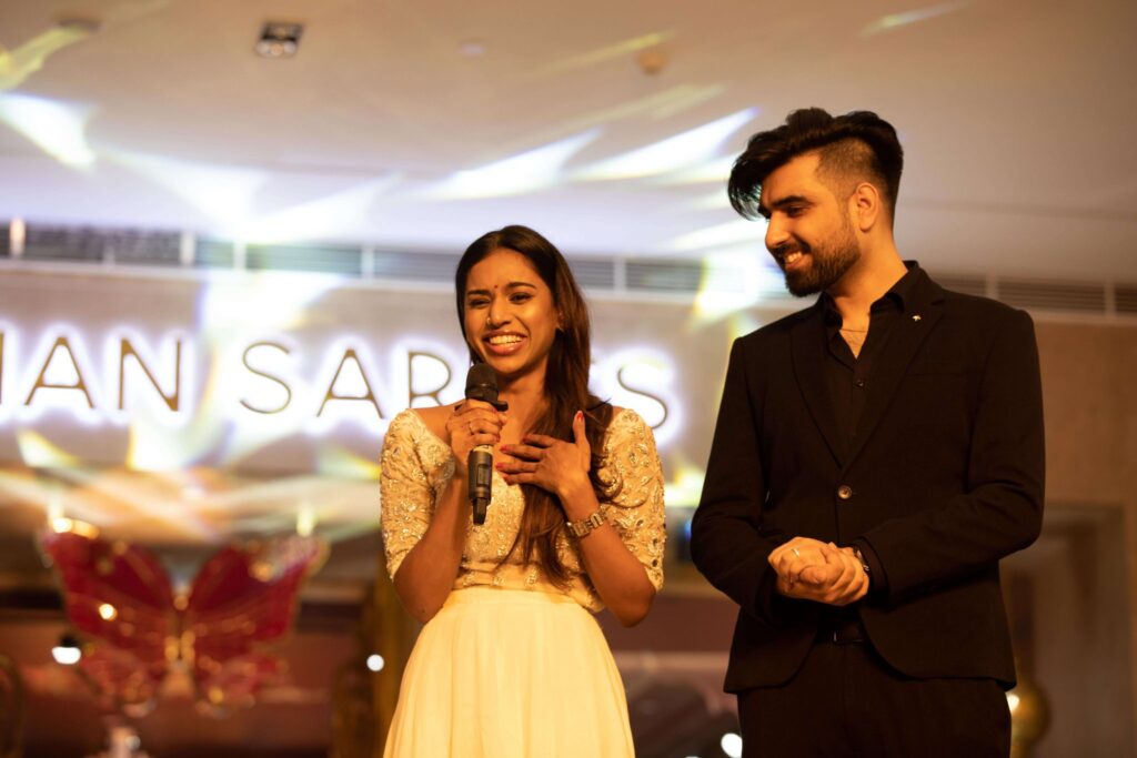 Yeshan Sarees founders speaking on stage at the brand's launch event