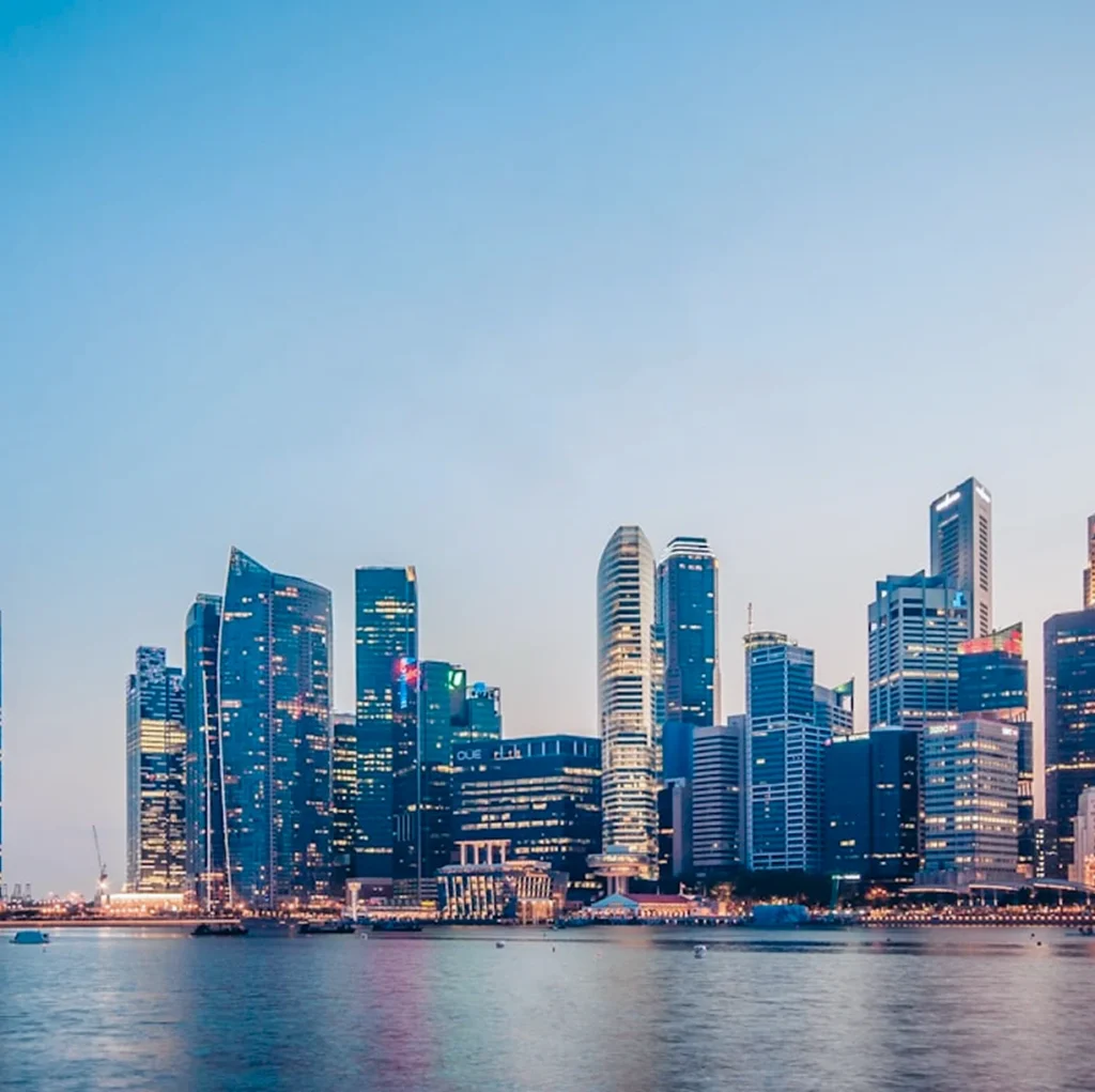 Singapore CBD skyline at dusk viewed across Marina Bay