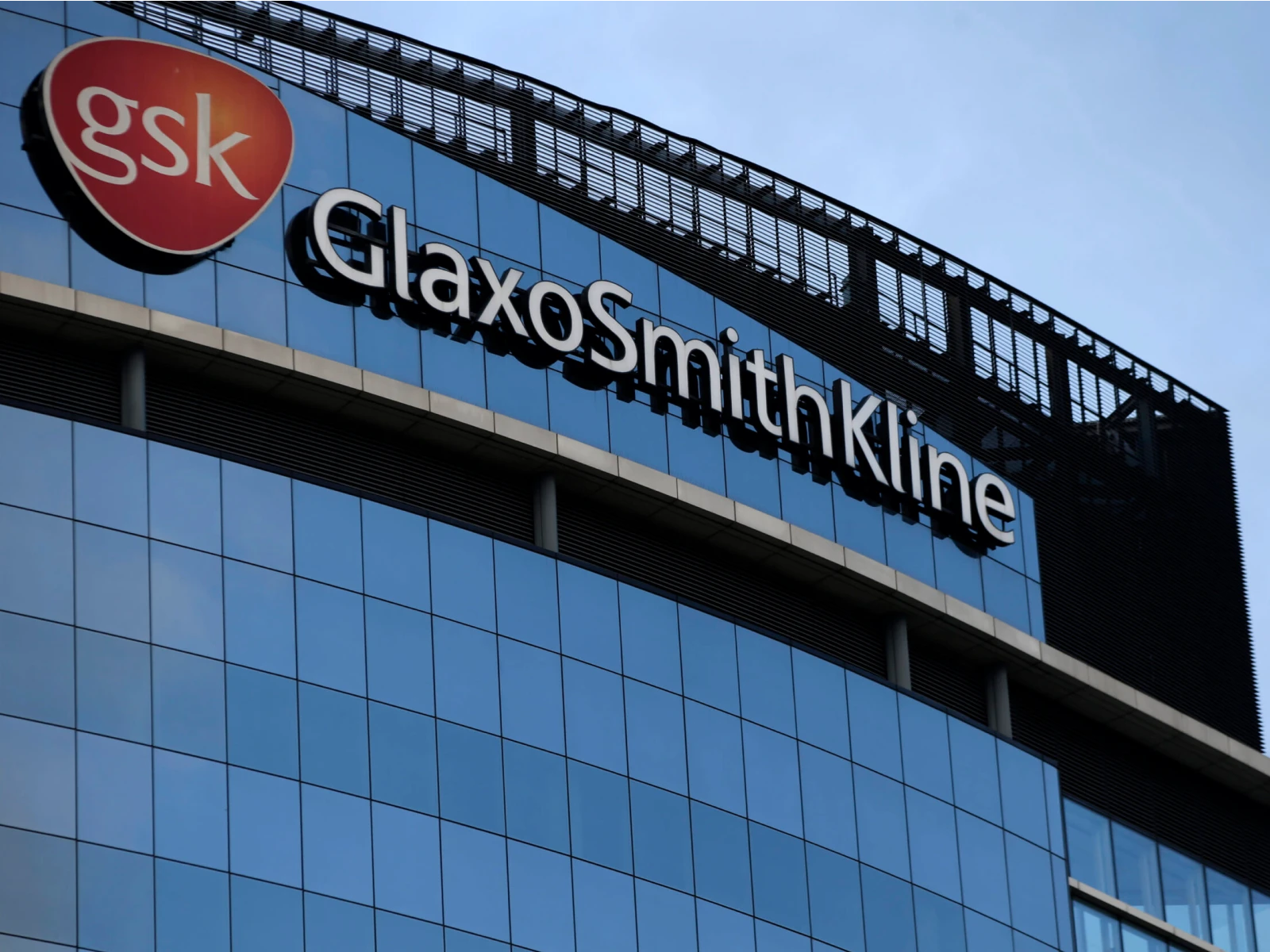 GlaxoSmithKline logo and signage on a modern glass office building