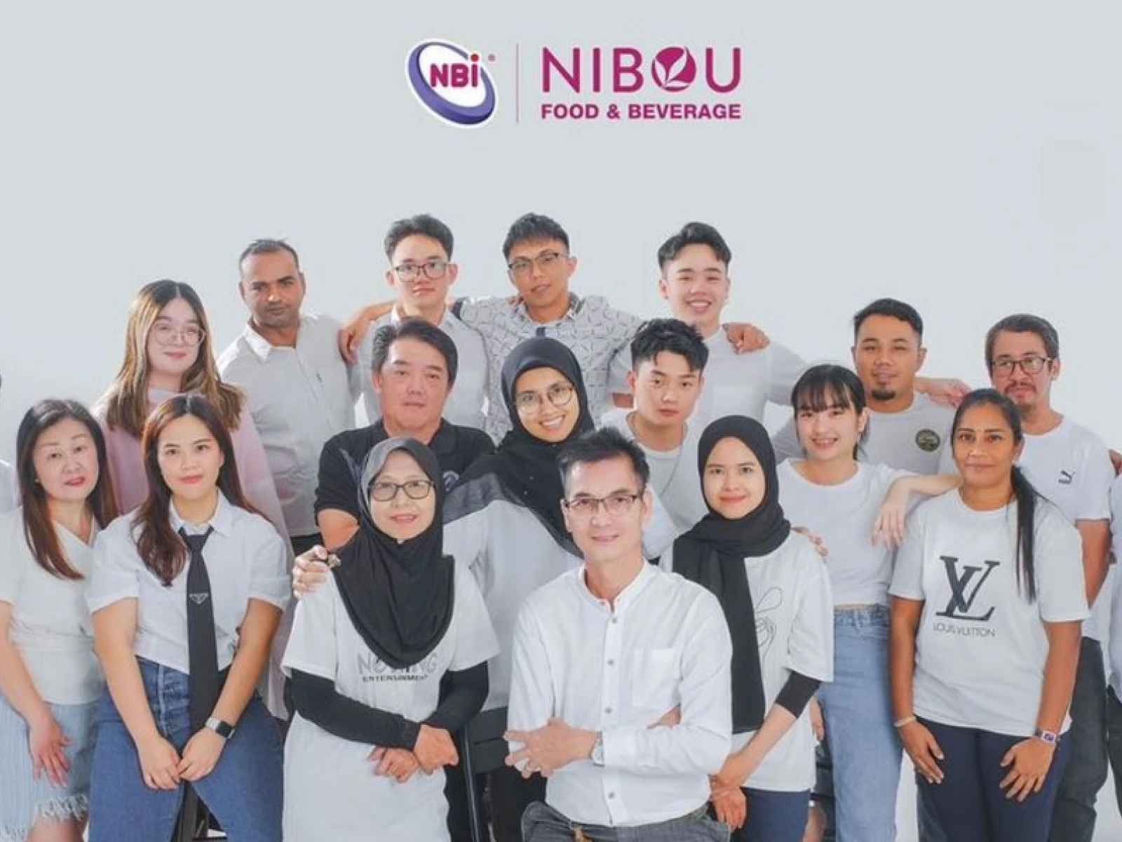 Nibou Food & Beverage team posing together under the company logo